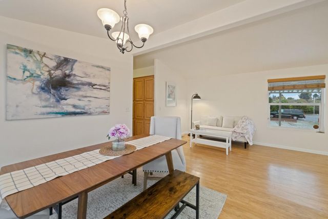 a kitchen with cabinets and wooden floor