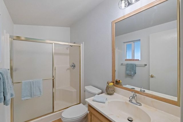 a large bed sitting in a bedroom and a table