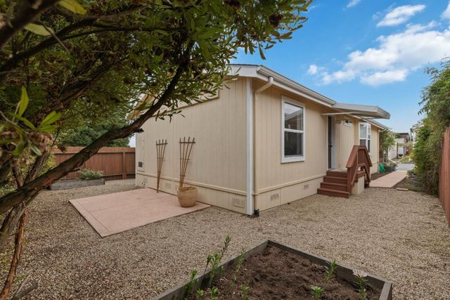 a kitchen with a sink a refrigerator and cabinets