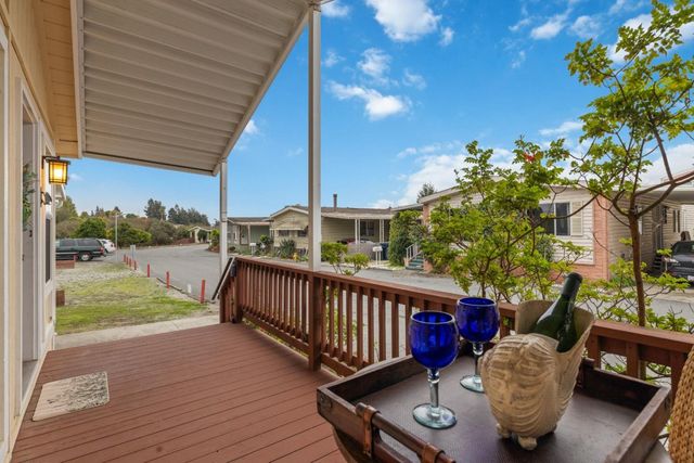 a view of a deck with couches and wooden floor