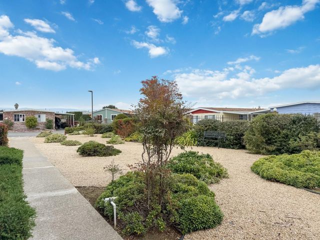 a backyard of a house with table and chairs