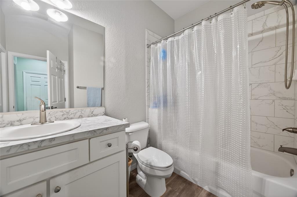 3415 West Anthony Road, Unit 303 Ocala, FL 34475 - Photo 11 of 29 a bathroom with a granite countertop sink toilet and shower