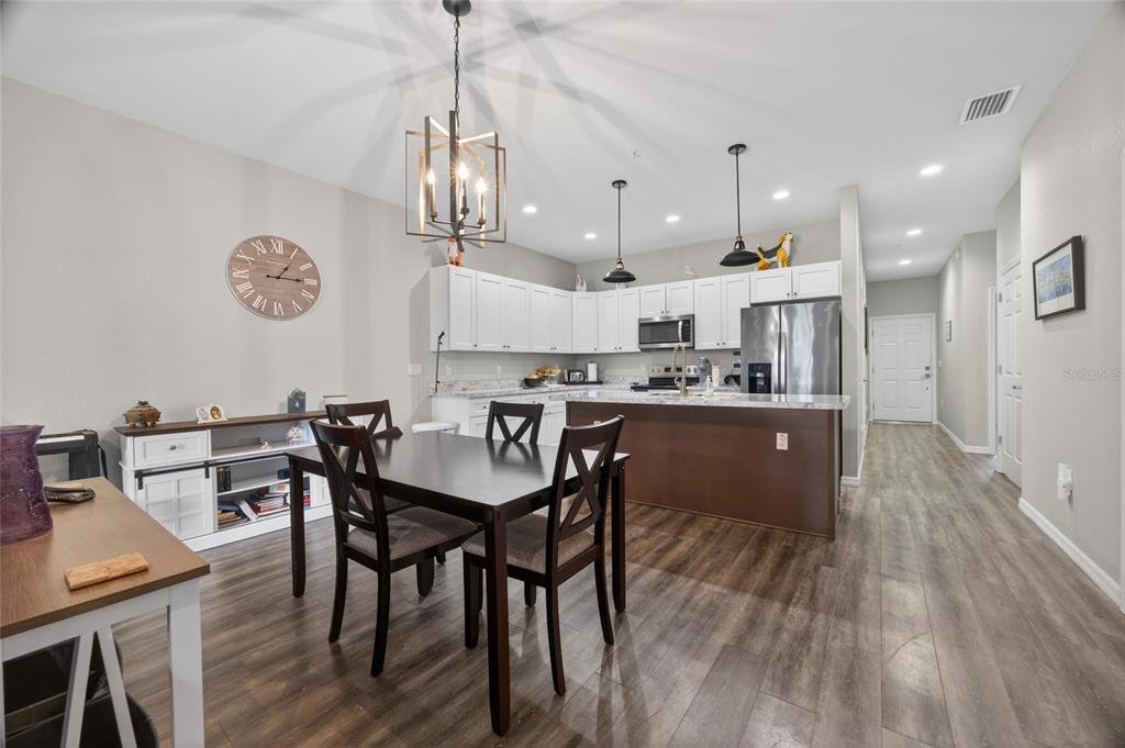 3415 West Anthony Road, Unit 303 Ocala, FL 34475 - Photo 12 of 29 a view of a dining room with furniture and wooden floor