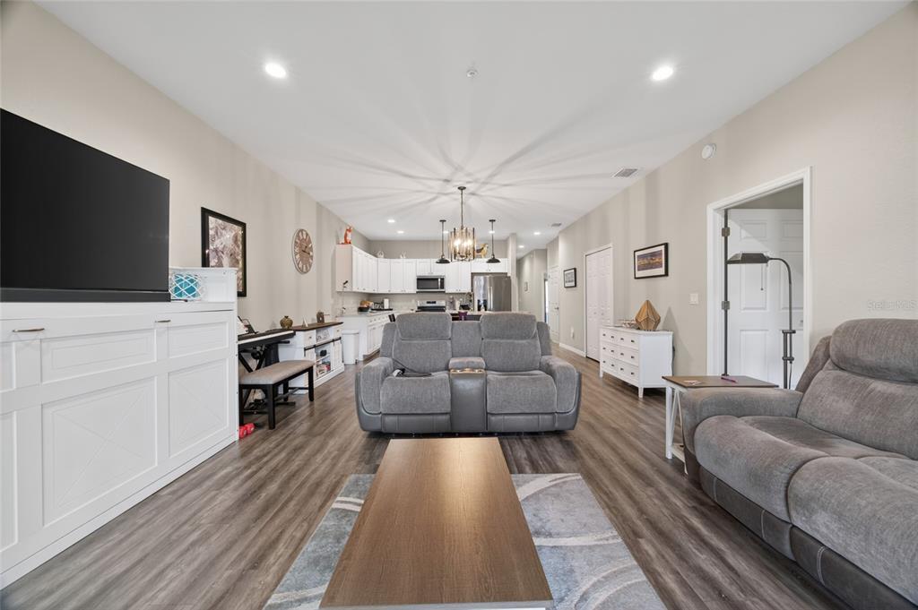 3415 West Anthony Road, Unit 303 Ocala, FL 34475 - Photo 13 of 29 a living room with furniture and a flat screen tv