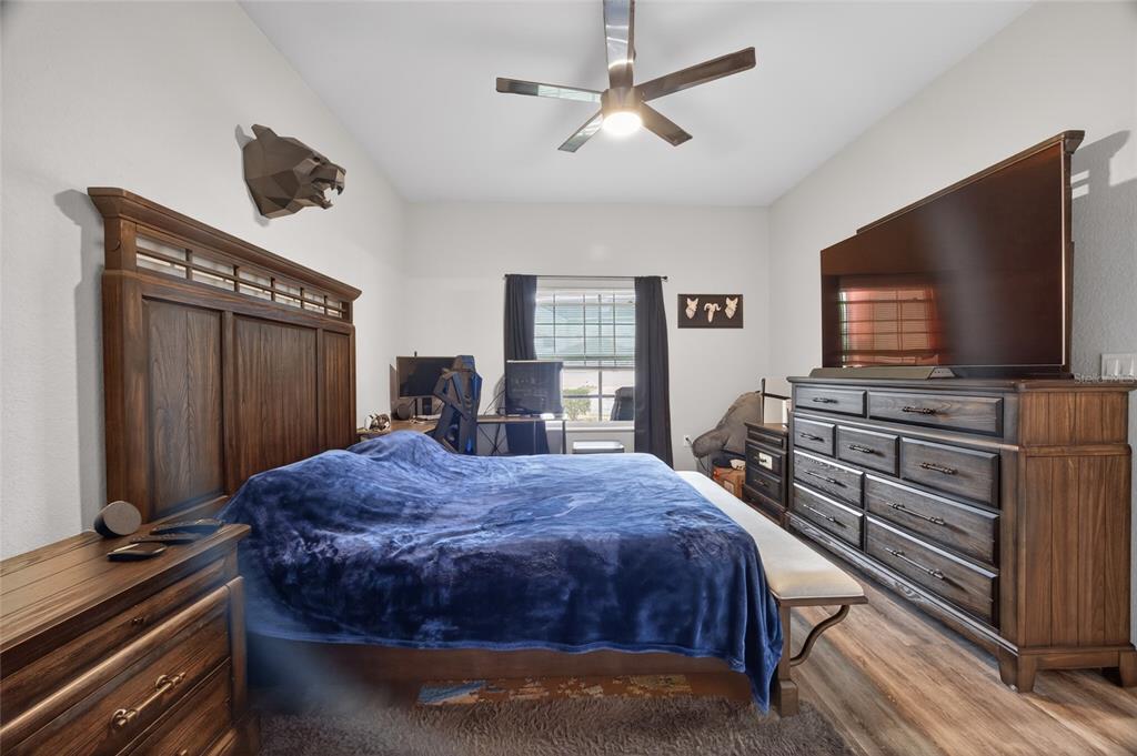 3415 West Anthony Road, Unit 303 Ocala, FL 34475 - Photo 16 of 29 a bedroom with a bed and a flat screen tv