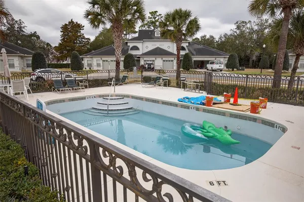 a view of a patio with swimming pool table and chairs