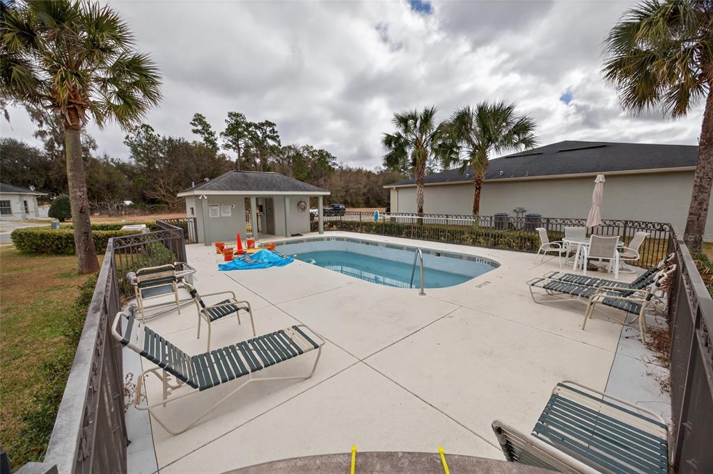 3415 West Anthony Road, Unit 303 Ocala, FL 34475 - Photo 28 of 29 a view of a patio with swimming pool table and chairs