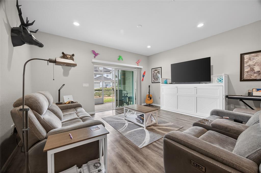 3415 West Anthony Road, Unit 303 Ocala, FL 34475 - Photo 6 of 29 a living room with furniture and a flat screen tv