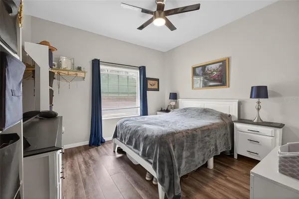 a bedroom with a bed dresser and a window