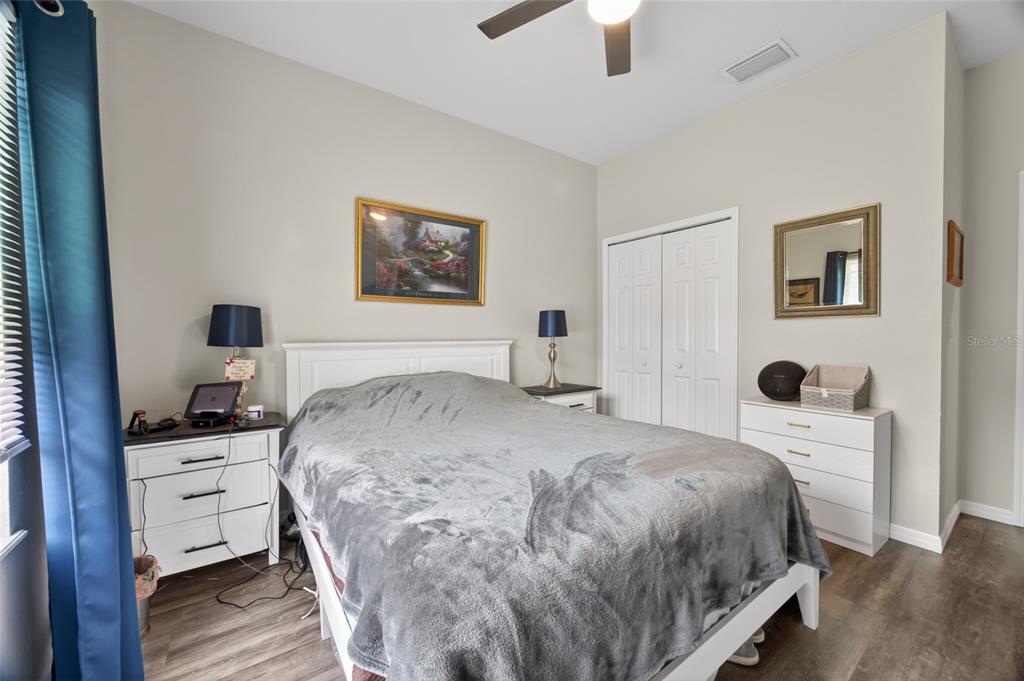 3415 West Anthony Road, Unit 303 Ocala, FL 34475 - Photo 10 of 29 a bedroom with a bed and a dresser