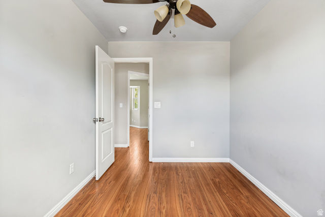 843 Deer Flat Road Tooele, UT 84074 - Photo 17 of 27 Room featuring wood-finish flooring, light grey painted walls, and white baseboards