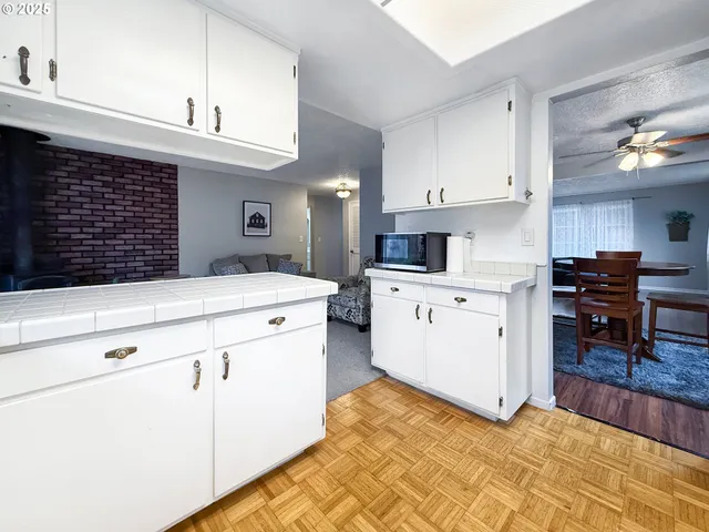 a kitchen with cabinets and chairs