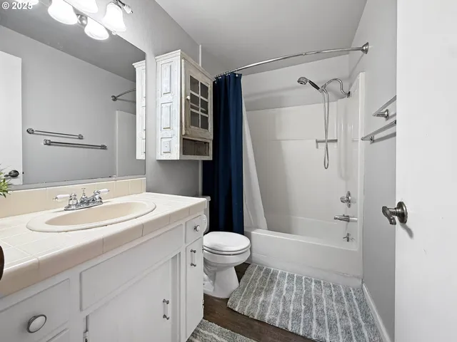 a bedroom with a bed table and window