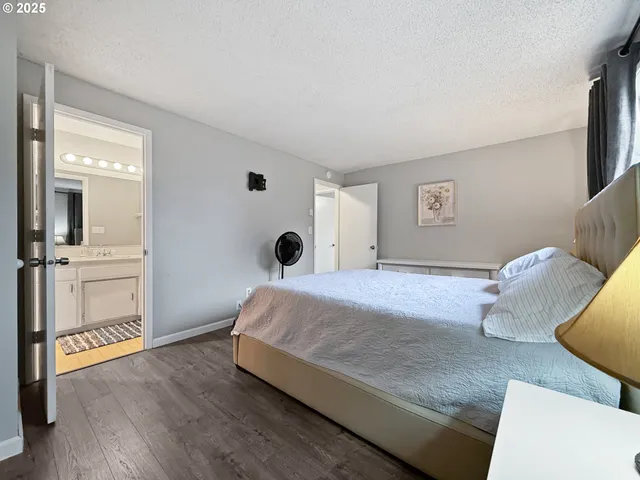 a bedroom with a bed and a night stand