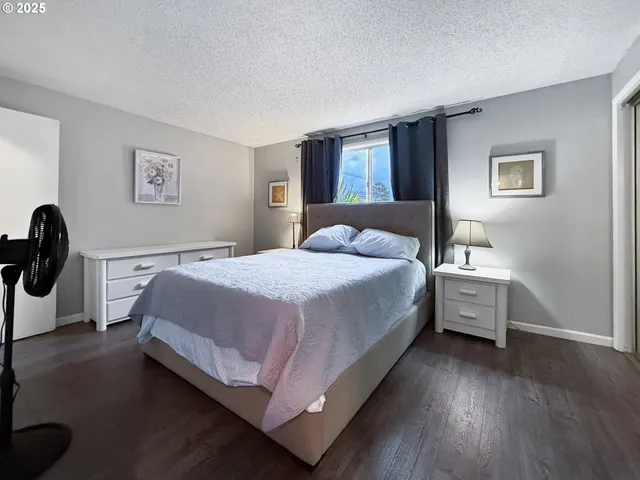 a bathroom with a granite countertop toilet sink and mirror