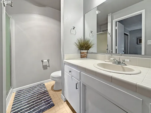 a bedroom with a bed and a potted plant