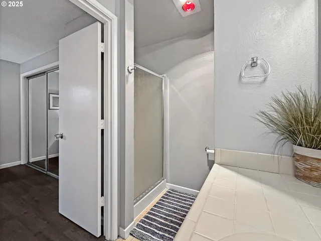 a spacious bathroom with a double vanity sink a toilet and a mirror