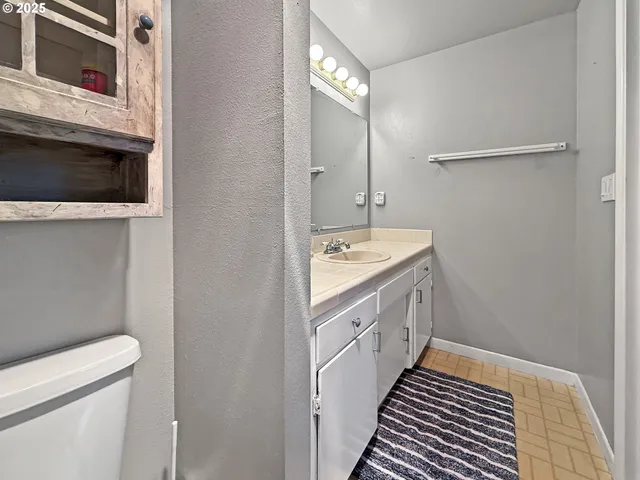 a bedroom with a bed and a desk next to a window