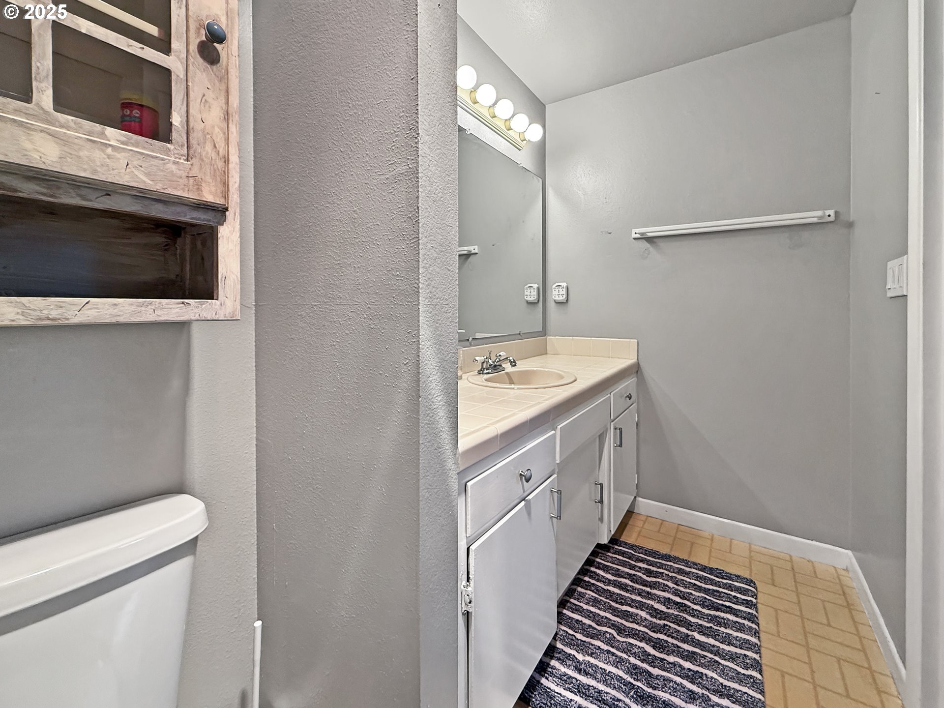 1330 Crissey Circle Brookings, OR 97415 - Photo 28 of 42 a spacious bathroom with a double vanity sink a toilet and a mirror
