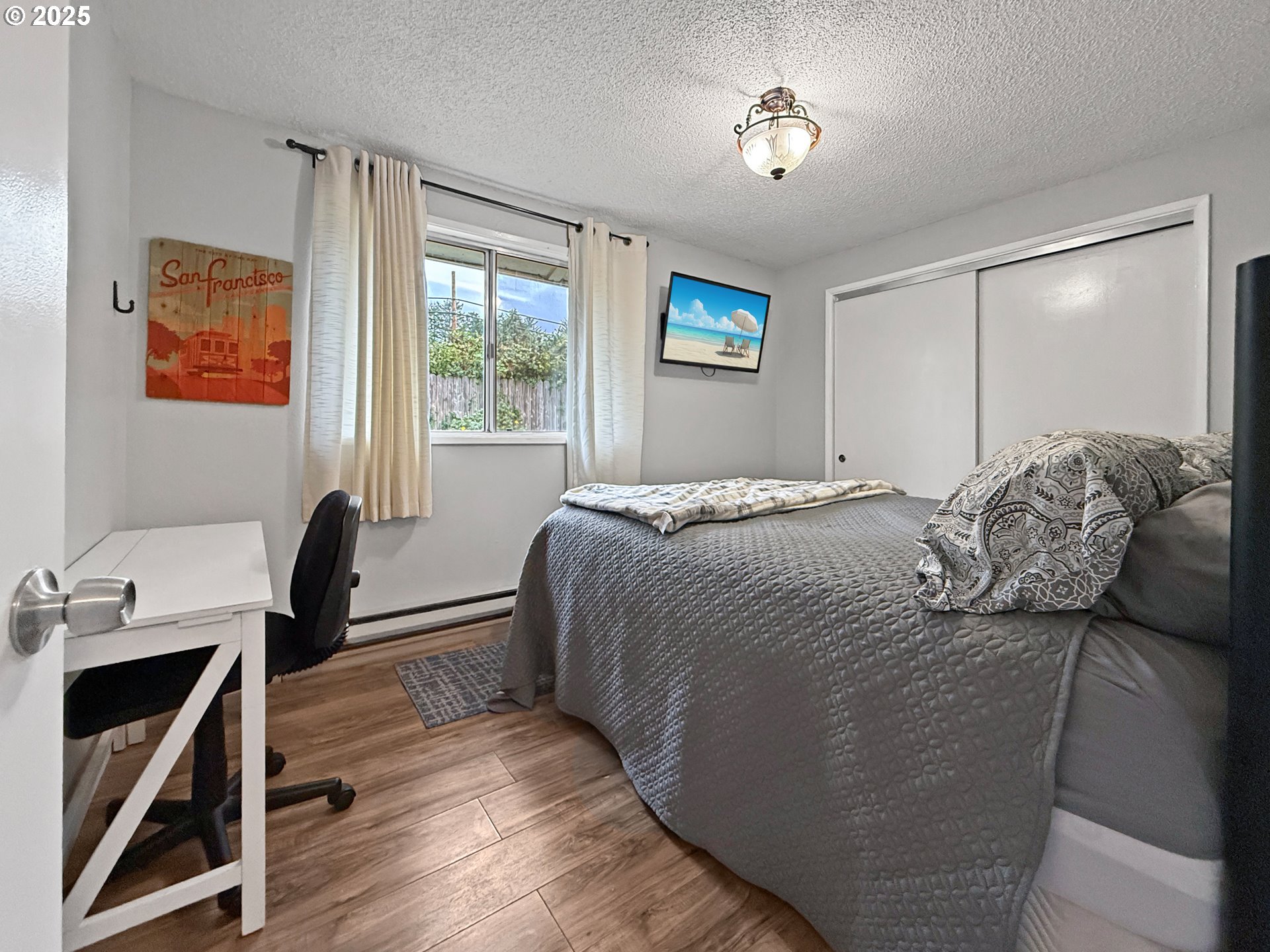 1330 Crissey Circle Brookings, OR 97415 - Photo 29 of 42 a bedroom with a bed and a desk next to a window