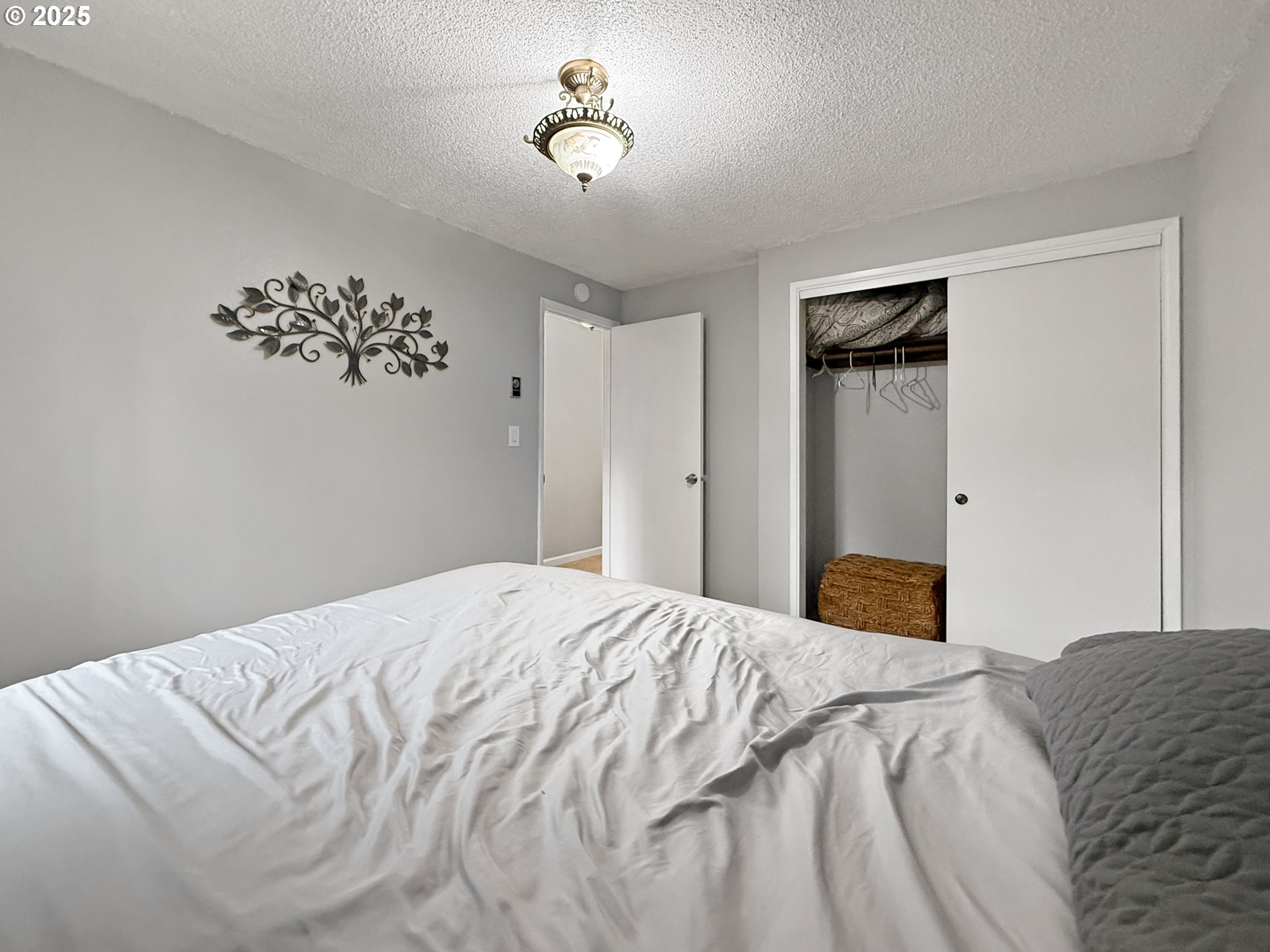 1330 Crissey Circle Brookings, OR 97415 - Photo 34 of 42 a bedroom with a bed and a chandelier