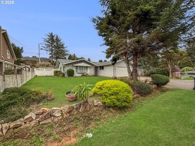 a view of a house with a yard and garage