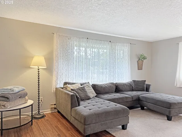a living room with furniture and a lamp