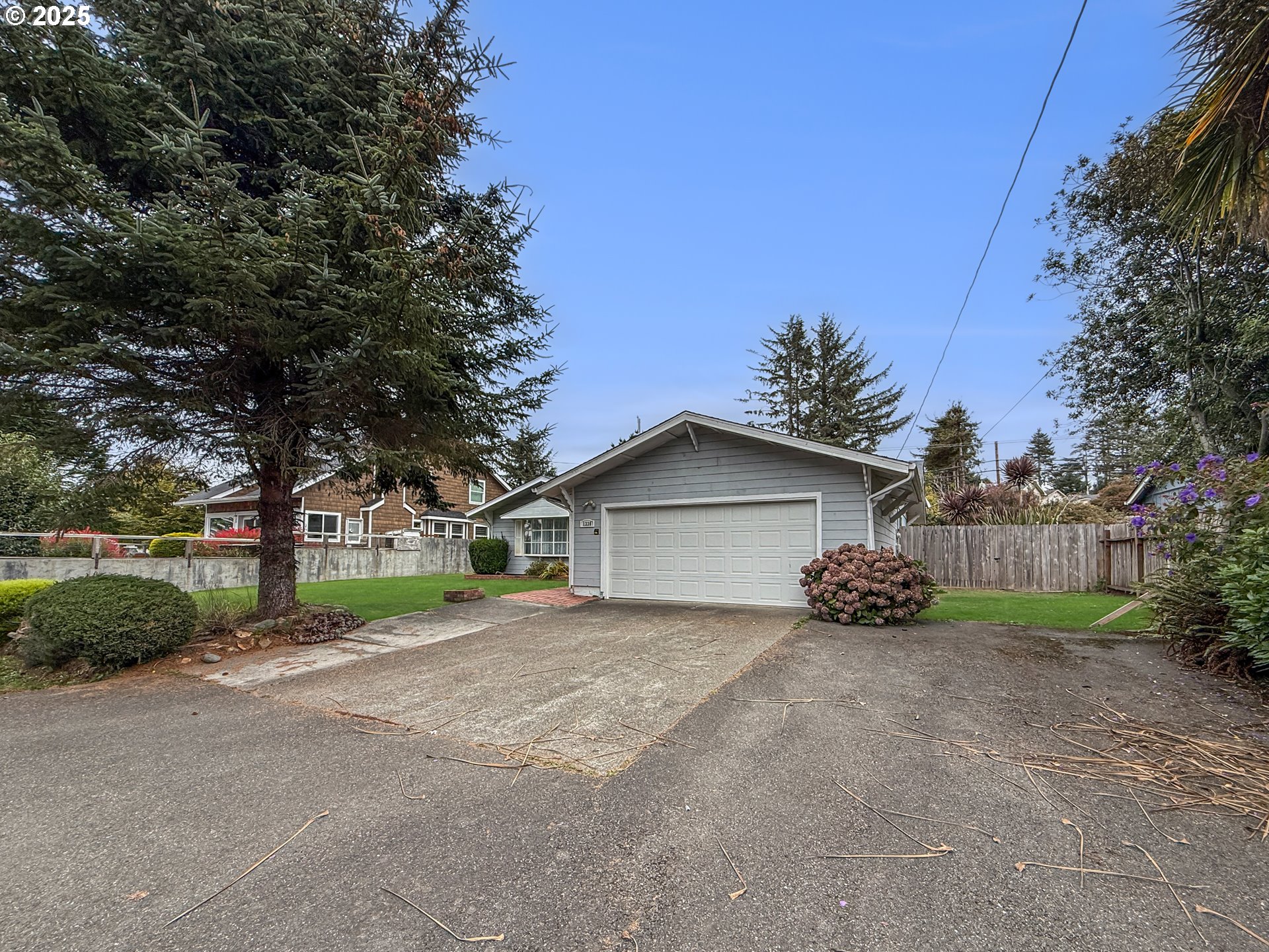 1330 Crissey Circle Brookings, OR 97415 - Photo 42 of 42 a view of a house with a yard and garage