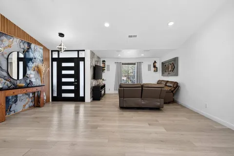 a living room with furniture and flat screen tv