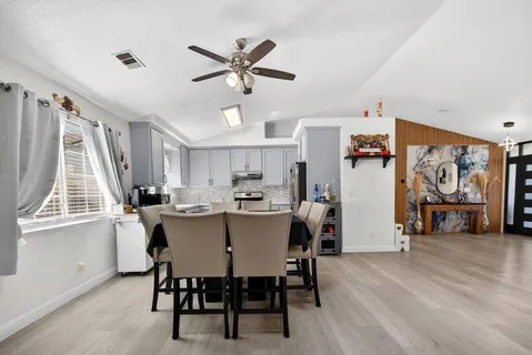 a dining room with furniture and window