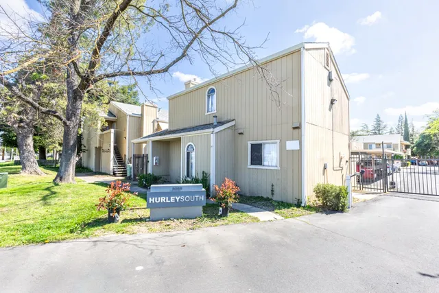 a front view of a house with a yard and outdoor seating