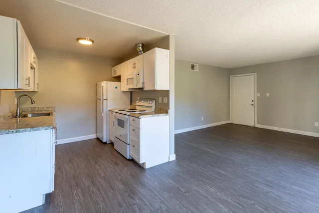 a kitchen with wooden cabinets and a stove top oven