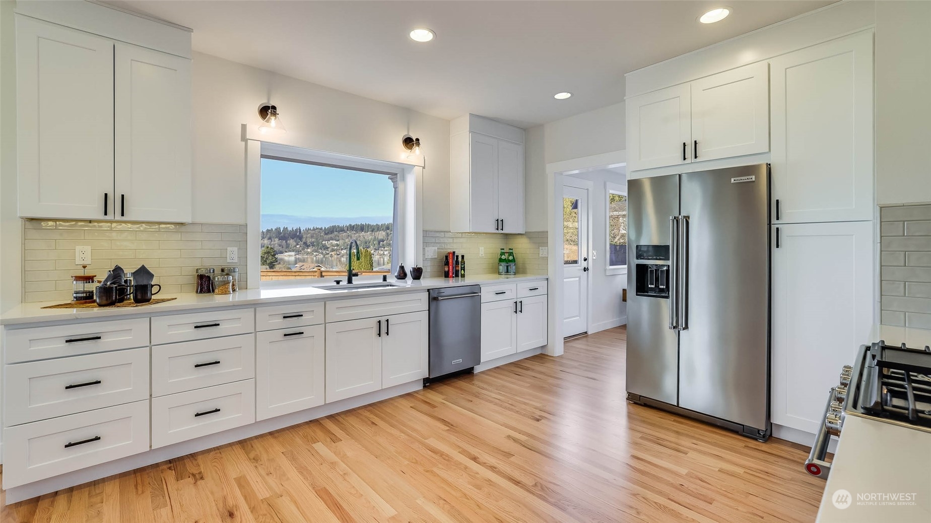 1018 North 34th Street Renton, WA 98056 - Photo 18 of 40 a large kitchen with stainless steel appliances sink a microwave and cabinets