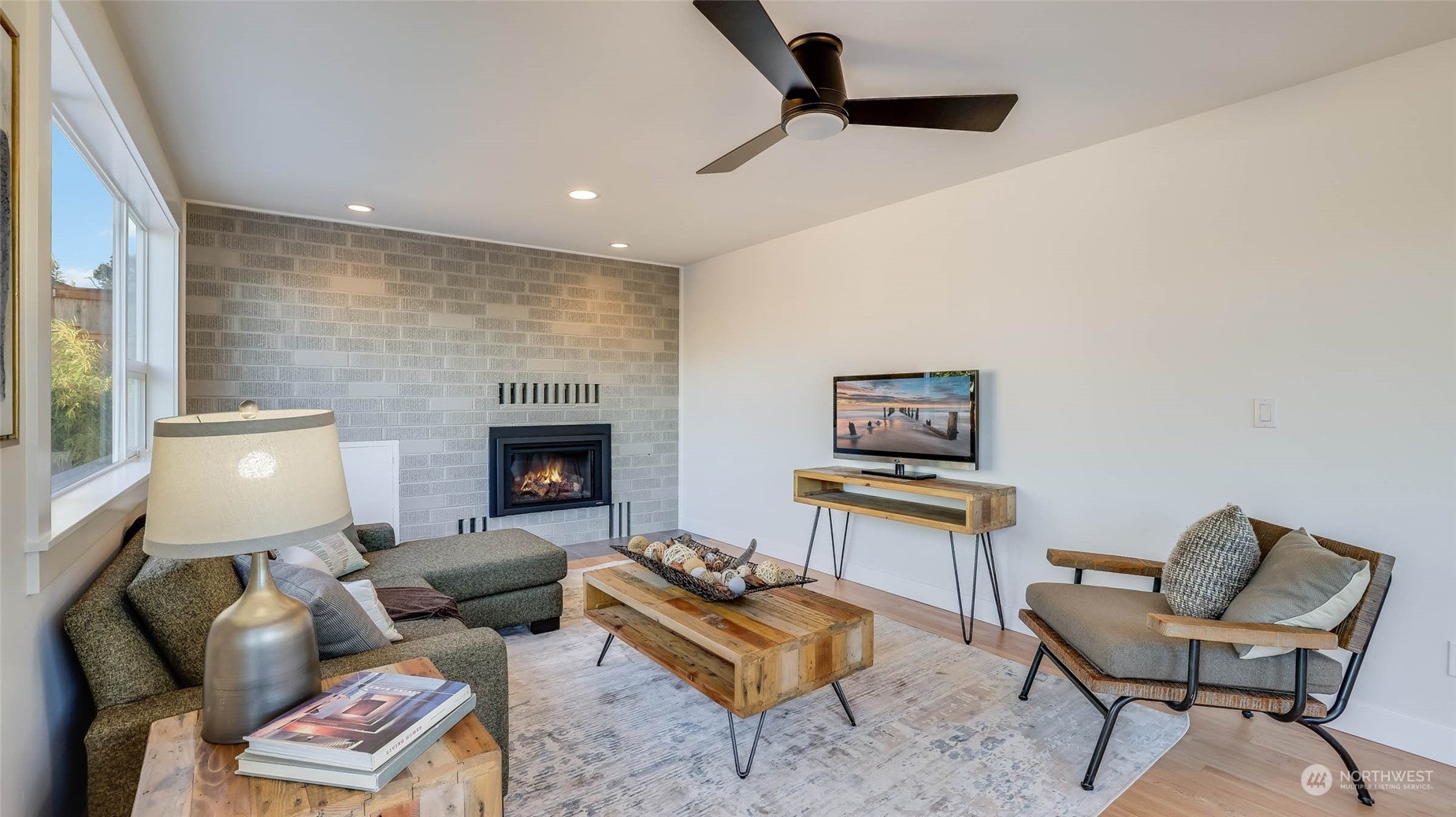 1018 North 34th Street Renton, WA 98056 - Photo 22 of 40 a living room with furniture and a fireplace