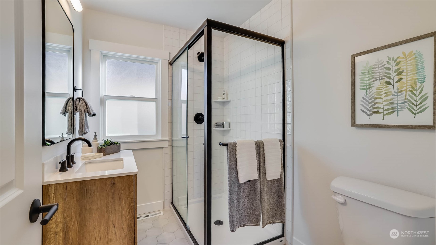 1018 North 34th Street Renton, WA 98056 - Photo 27 of 40 a bathroom with a sink and mirror with toilet