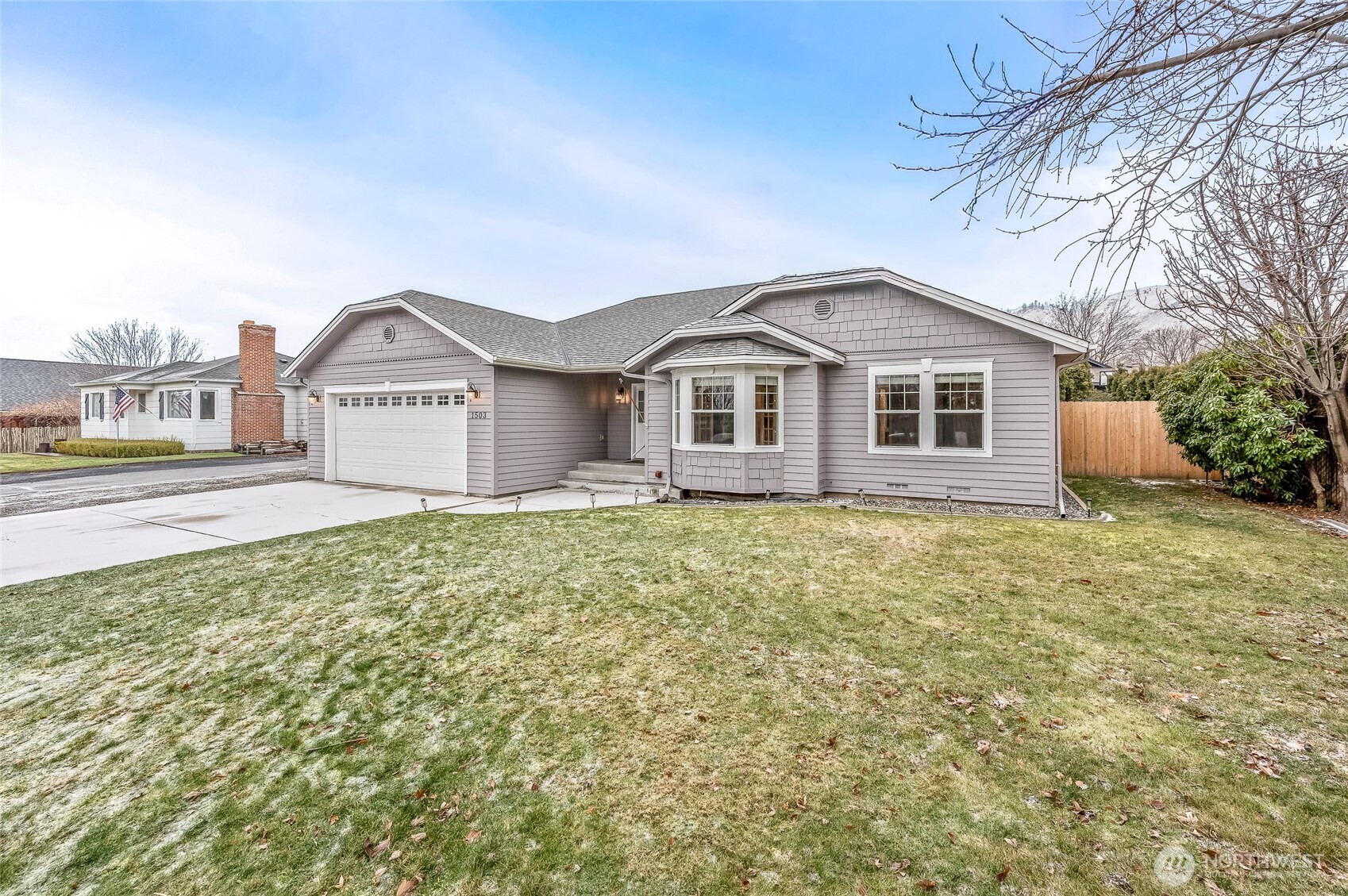 1503 Castlerock Avenue Wenatchee, WA 98801 - Photo 1 of 37 a view of a house with a yard and large trees
