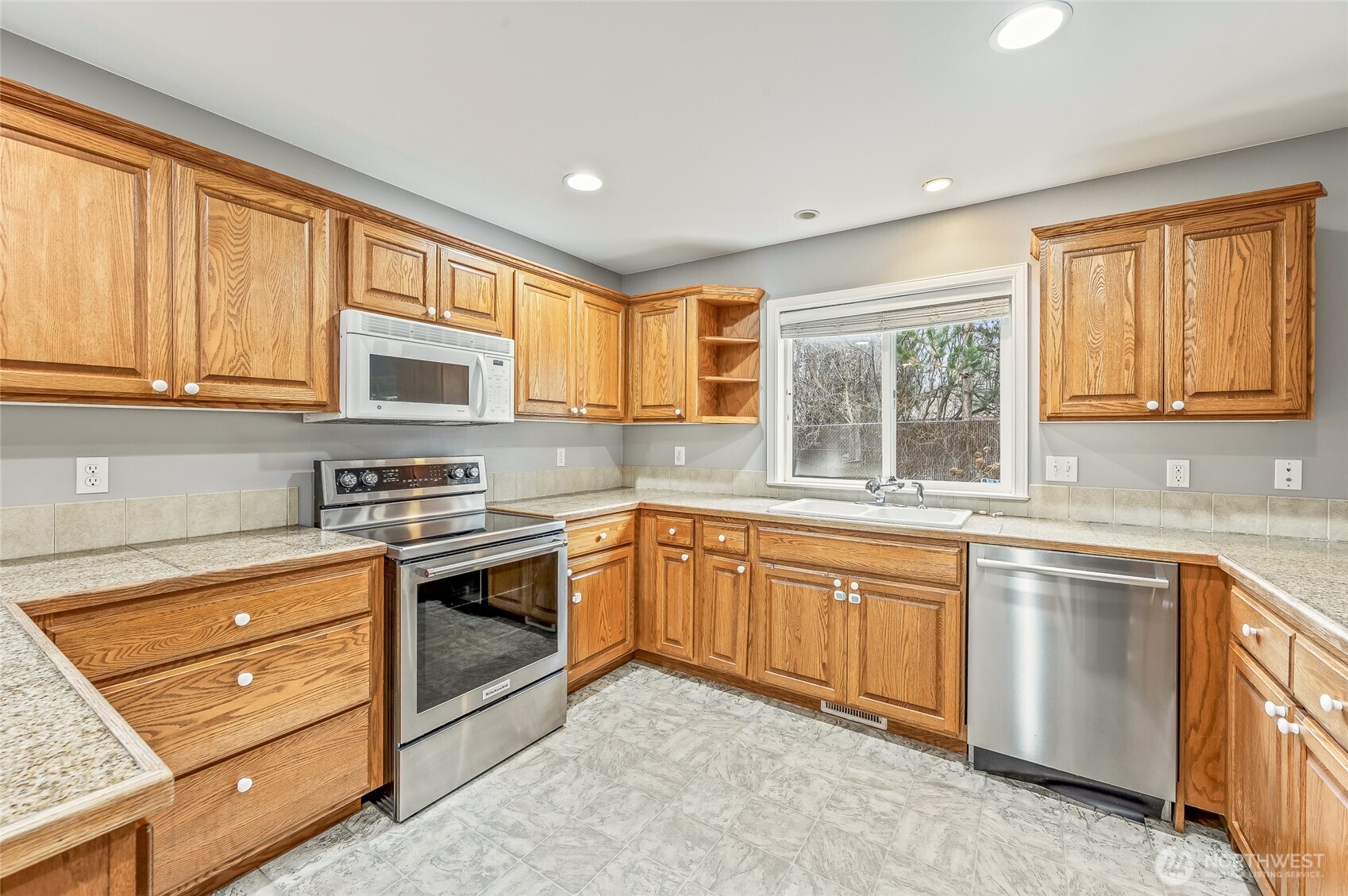 1503 Castlerock Avenue Wenatchee, WA 98801 - Photo 12 of 37 a kitchen with stainless steel appliances granite countertop a stove sink and cabinets