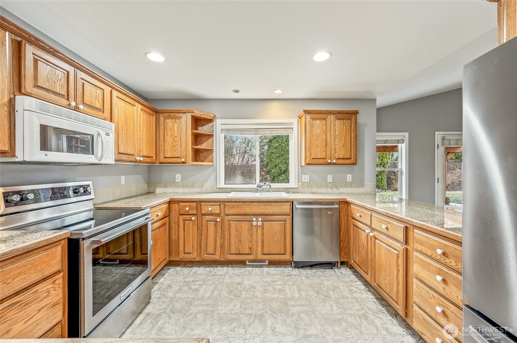 1503 Castlerock Avenue Wenatchee, WA 98801 - Photo 14 of 37 a large kitchen with stainless steel appliances granite countertop a stove a sink and a microwave