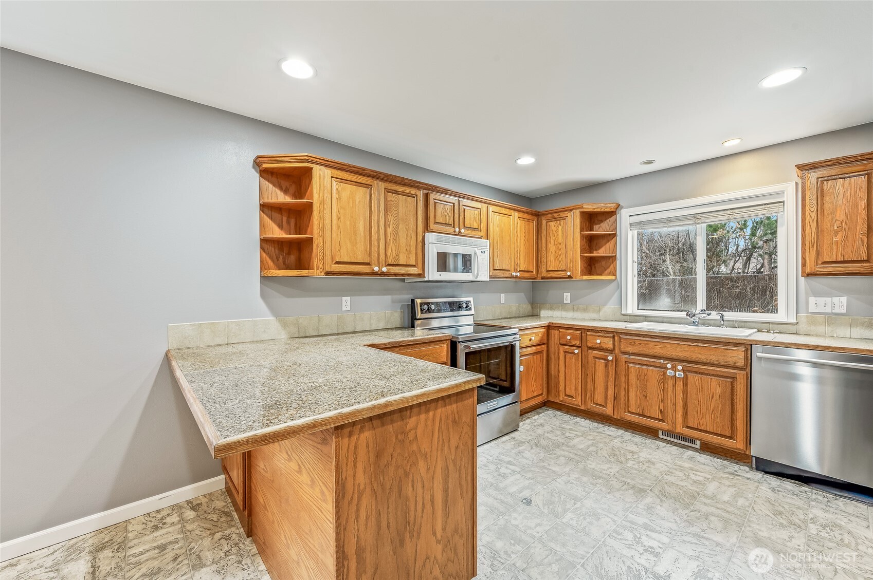1503 Castlerock Avenue Wenatchee, WA 98801 - Photo 15 of 37 a kitchen with stainless steel appliances granite countertop sink stove top oven and cabinets