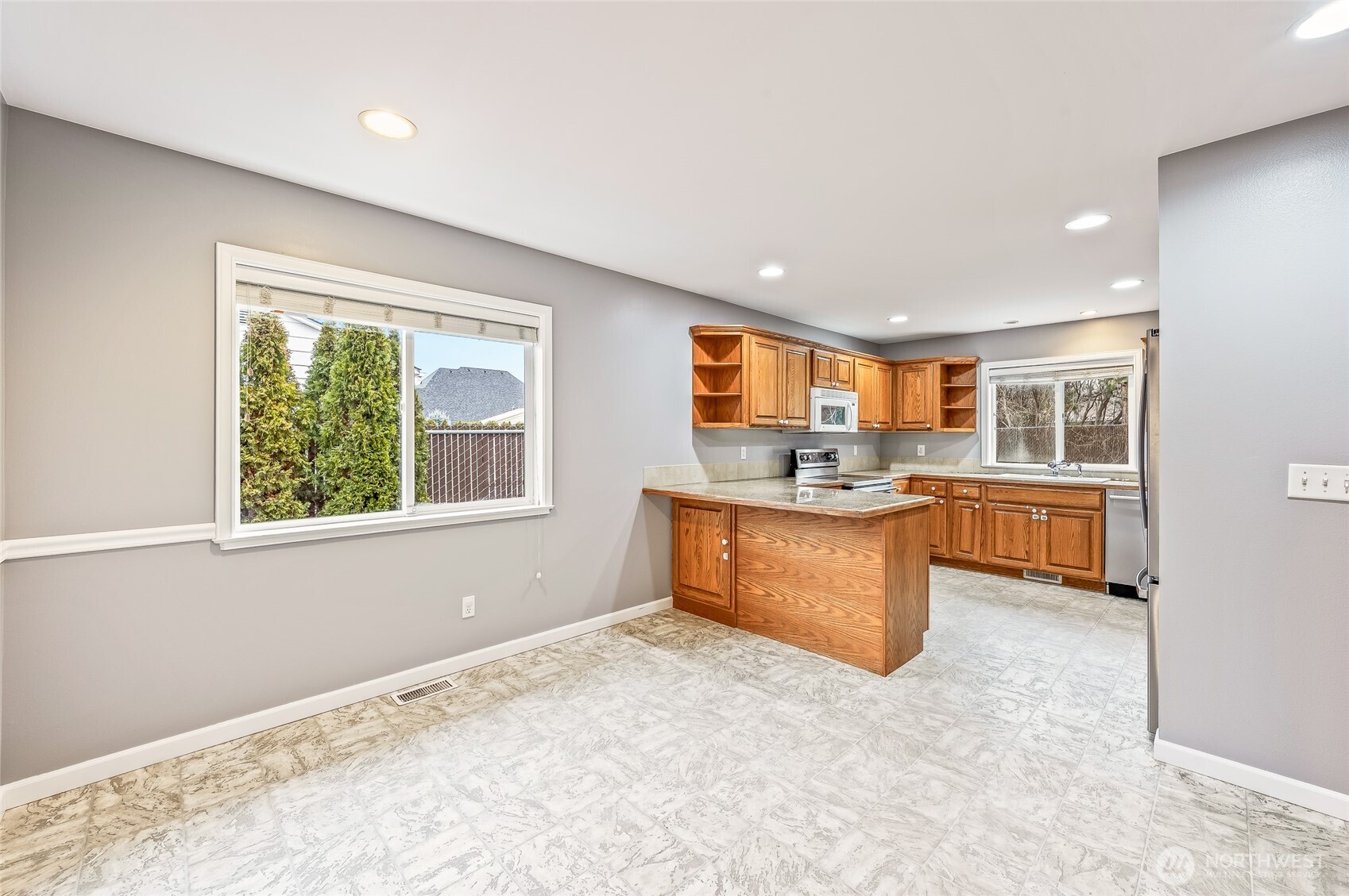 1503 Castlerock Avenue Wenatchee, WA 98801 - Photo 18 of 37 a kitchen with stainless steel appliances granite countertop a sink stove and refrigerator