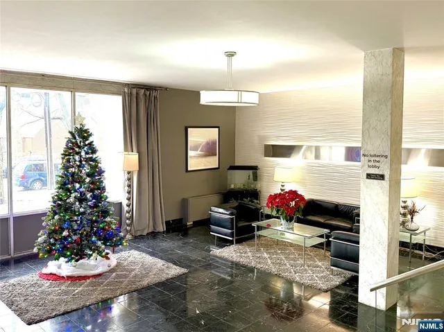 a living room with furniture and a christmas tree
