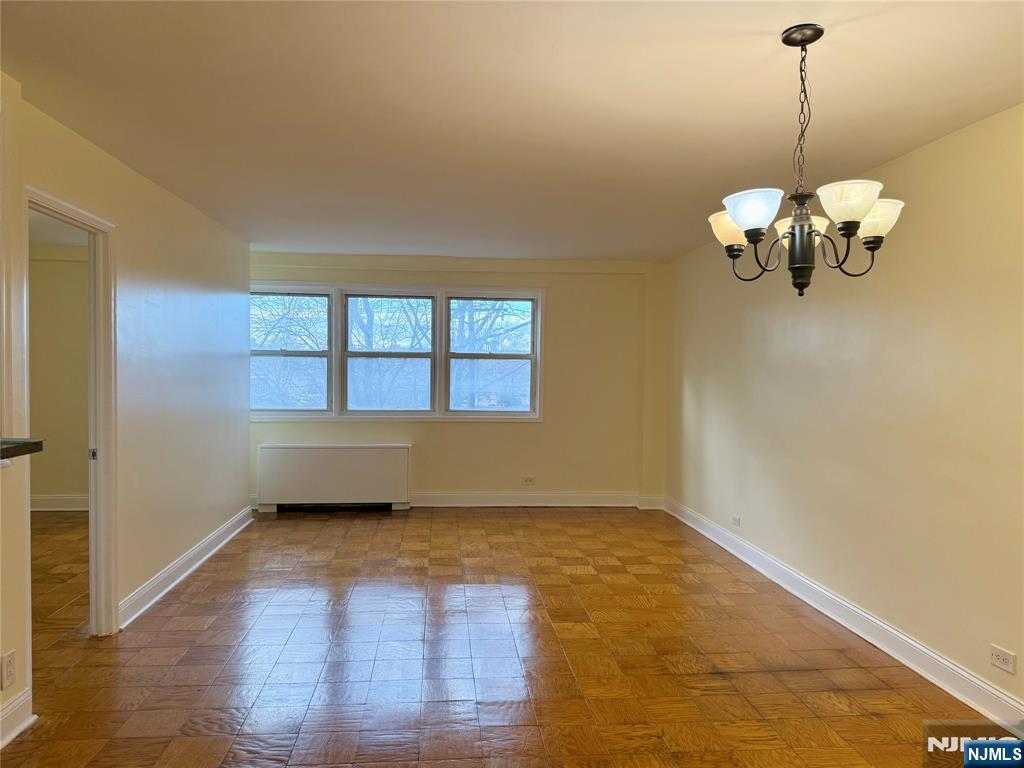 39 East 39th Street, Unit 3H Paterson, NJ 07514 - Photo 4 of 19 a view of an empty room with a window and wooden floor