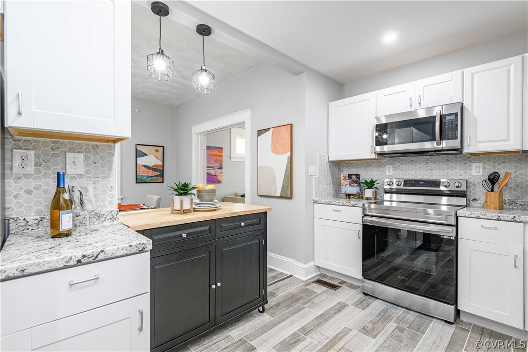3103 Letcher Avenue Richmond, VA 23222 - Photo 20 of 50 a kitchen with stainless steel appliances granite countertop a sink and cabinets