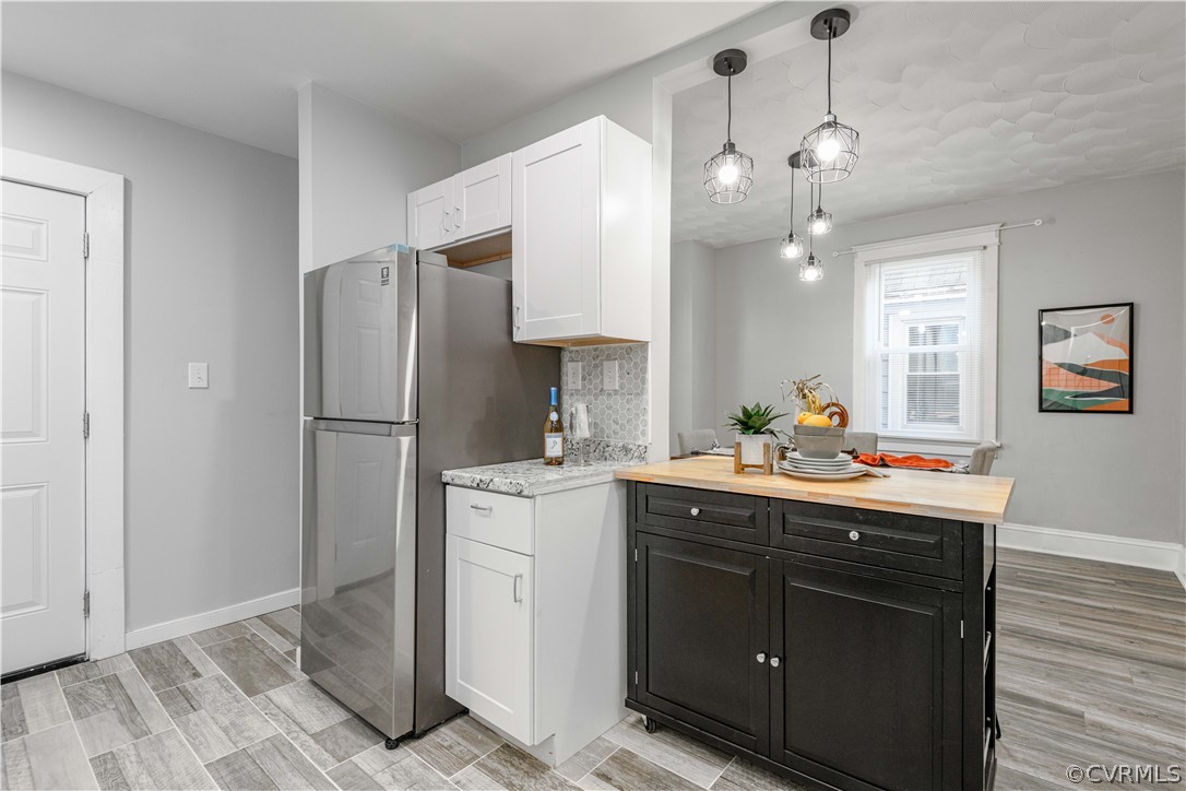 3103 Letcher Avenue Richmond, VA 23222 - Photo 25 of 50 a kitchen with a refrigerator a sink and dishwasher with white cabinets
