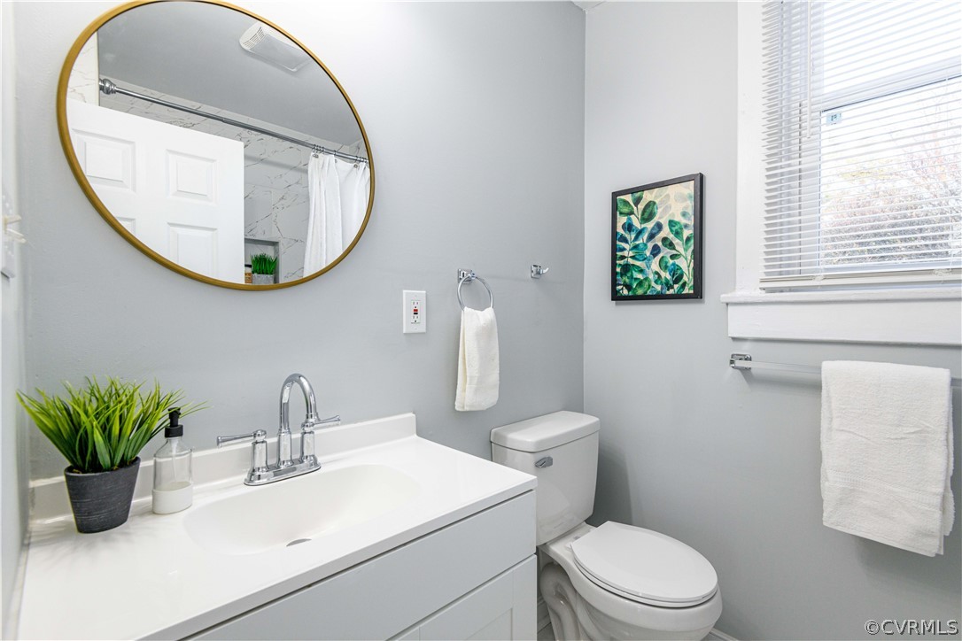 3103 Letcher Avenue Richmond, VA 23222 - Photo 36 of 50 a bathroom with a toilet a sink and a mirror