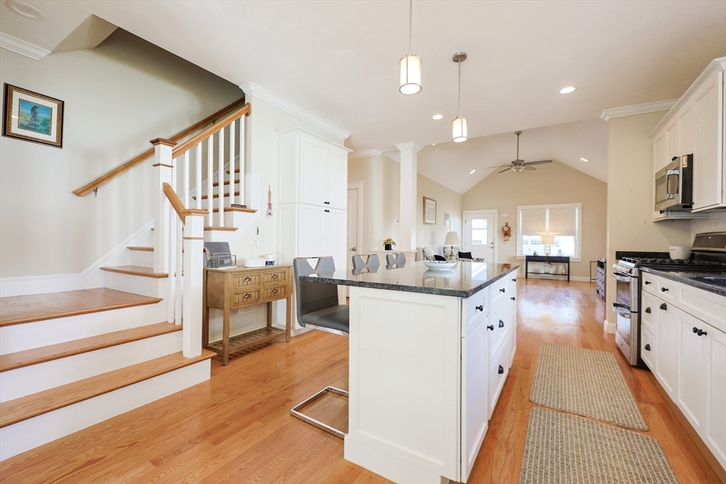 47 Compass Point Drive, Unit 47 Douglas, MA 01516 - Photo 18 of 32 a kitchen with sink cabinets and wooden floor