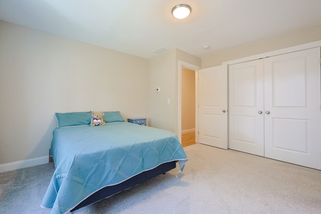 47 Compass Point Drive, Unit 47 Douglas, MA 01516 - Photo 21 of 32 a bedroom with a bed and cabinets