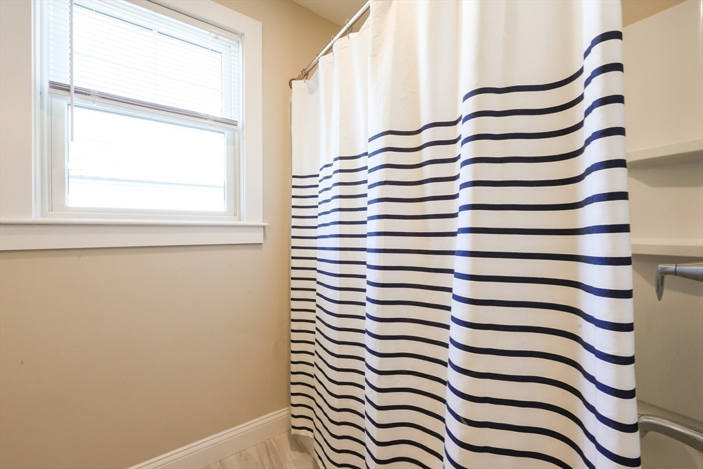 47 Compass Point Drive, Unit 47 Douglas, MA 01516 - Photo 24 of 32 a view of a bathroom with a window and a shower