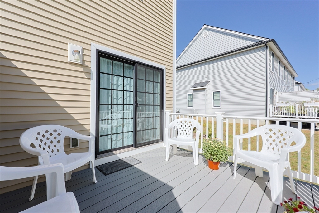 47 Compass Point Drive, Unit 47 Douglas, MA 01516 - Photo 28 of 32 a balcony with wooden floor table and chairs