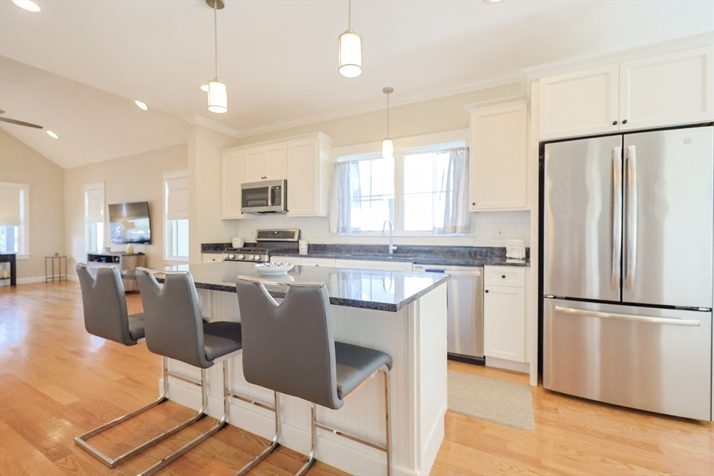 47 Compass Point Drive, Unit 47 Douglas, MA 01516 - Photo 8 of 32 a kitchen with a refrigerator a stove a sink a dining table and chairs
